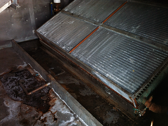 Corroded HVAC drain pan before restoration